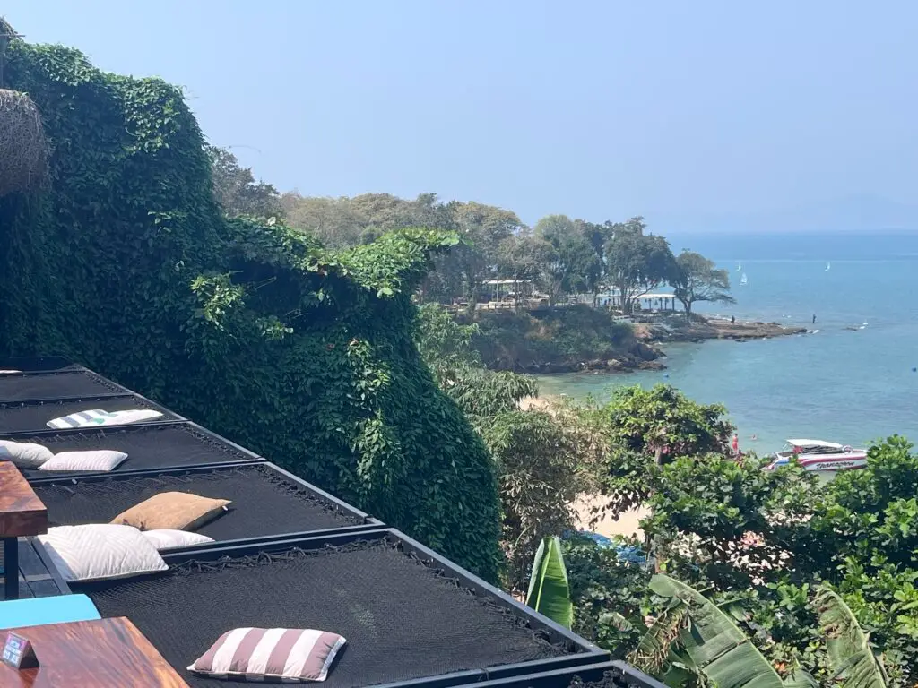 The outdoor seating area at Three Mermaids cafe in Pattaya, featuring ocean views and whimsical mermaid-inspired decor.
