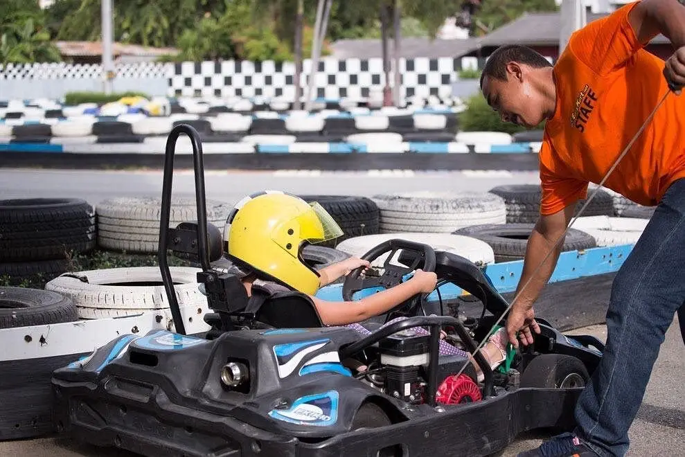 a kid about to race a go kart in pattaya , awesome family fun