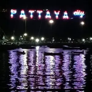The new Pattaya City sign at night with its reflection on the sea